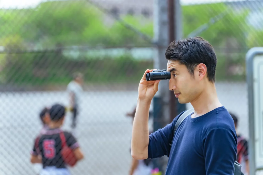 高校野球部の練習を見るスポーツライター