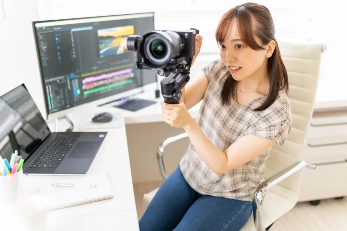 撮影機材や映像編集ソフトの操作を学ぶ女子大学生